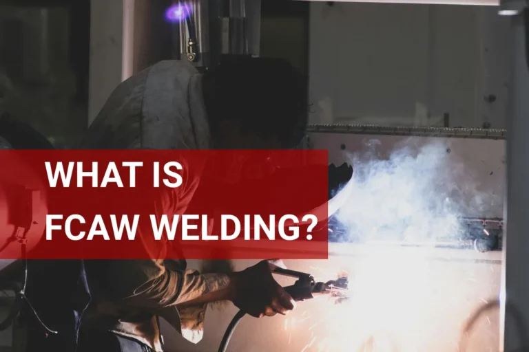 Welder engaged in FCAW welding indoors in Mumbai, wearing protective gear and surrounded by flying sparks.