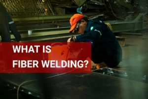 Skilled welder performing fiber welding techniques in a modern manufacturing facility.