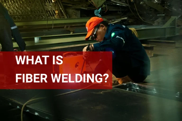 Skilled welder performing fiber welding techniques in a modern manufacturing facility.