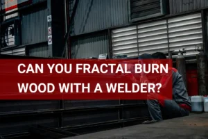 Welder creating intricate designs by fractal burning wood in a workshop environment.