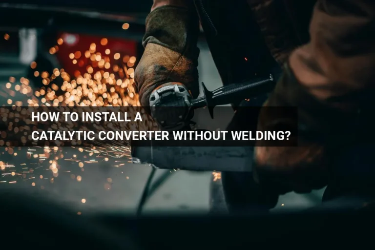 Worker installing a catalytic converter without welding, using an angle grinder to ensure a precise fit in a factory environment.