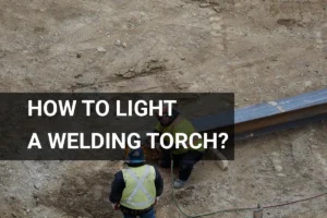 Construction workers demonstrating how to light a welding torch while welding steel beams at a construction site.