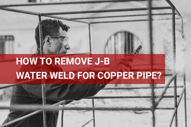 Close-up image of a welder removing J-B Water Weld from a copper pipe in a workshop setting.