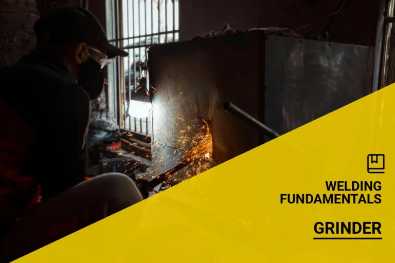 Metalworker removing a weld with a grinder, generating sparks in an industrial workshop environment.