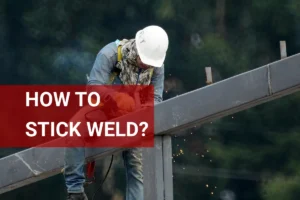 A construction worker performing stick welding on a steel beam, demonstrating proper technique and showcasing sparks in industrial welding work.