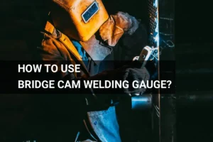 A welder using a bridge cam welding gauge in a dimly lit industrial setting, ensuring precision and safety while working with metal.