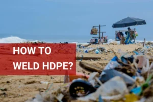 Welding HDPE plastic materials on a sandy beach with ocean debris in the background and vendors under umbrellas.