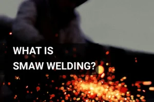 Welder performing SMAW welding outdoors, surrounded by bright sparks and dynamic motion.