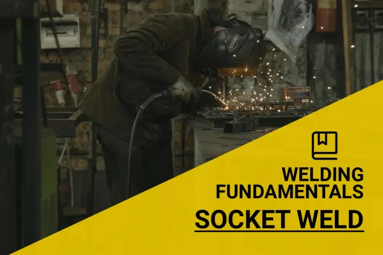 Welder performing socket welds to join metal pieces in a workshop filled with tools and sparks.