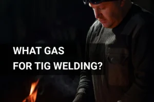 Man performing TIG welding with argon gas in workshop, concentrating on precision metalwork techniques.