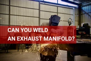 Welder grinding an exhaust manifold in a workshop, sparks flying, showcasing the welding process in Lampa, Chile.