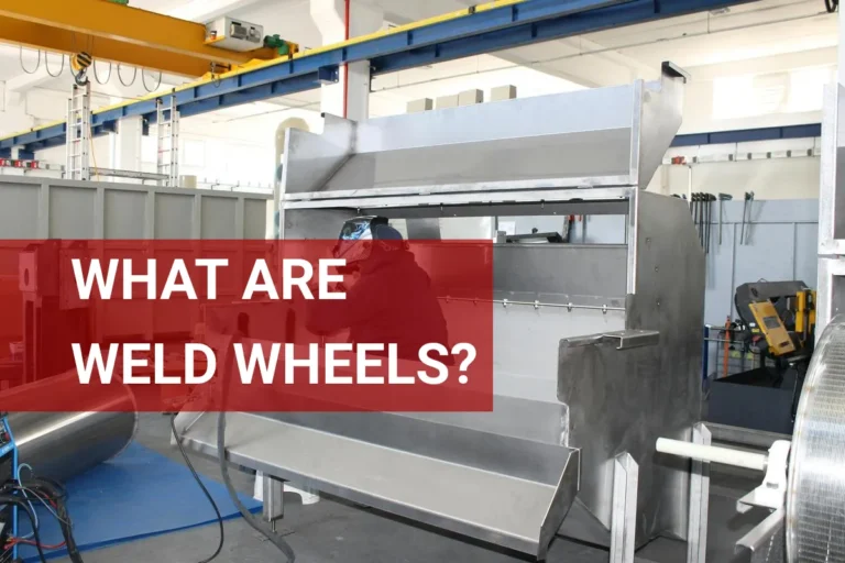 Welding worker assembling custom weld wheels in a busy industrial factory.