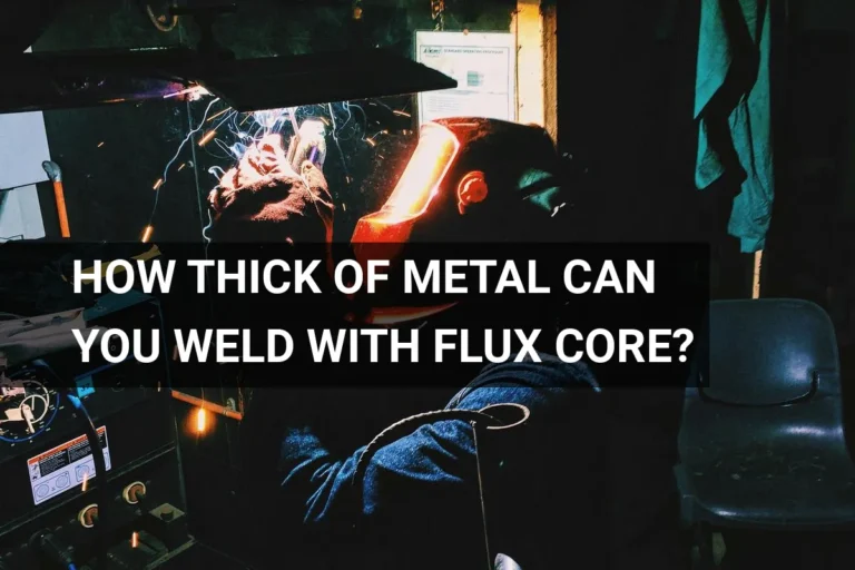 Welder using a flux core welding machine to join thick metal in an industrial environment, with sparks flying around.