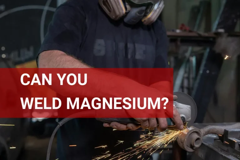 Skilled worker in safety gear grinding magnesium metal with sparks flying in a well-equipped workshop.