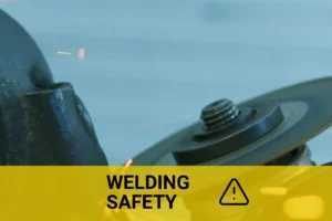 Close-up view of welding sparks flying as a grinder cuts metal, illustrating key factors that cause porosity in welding.