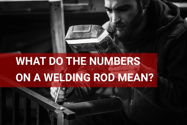 A detailed close-up of a welder examining the specifications on a welding rod, highlighting the meaning of the numbers on it.