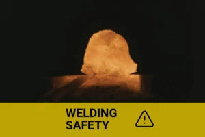 Close-up view of a welder working with intense sparks and bright light, highlighting the risks of sunburn from welding activities.