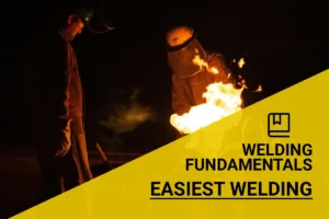 Beginners exploring the easiest welding techniques can observe industrial workers in protective gear mastering the fiery welding process at night.