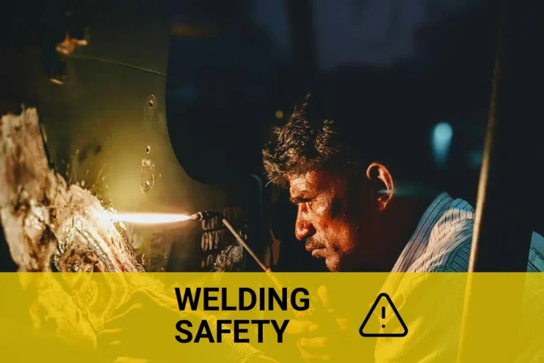 Welder working intensely at night in Kalaburagi, India, emphasizing the dangers of welding without a mask and the importance of safety precautions.