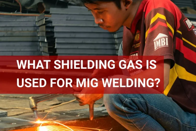 Close-up of a man squatting and performing MIG welding using shielding gas for optimal weld quality.